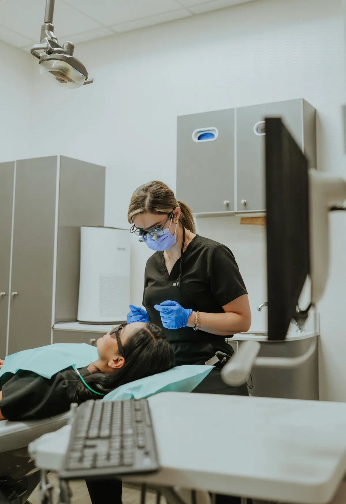 Spire Dental Care dentist Dr. Ghazvini working on tooth cap for a patient